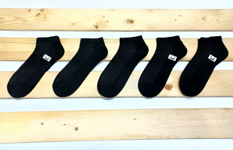 Men's ankle socks; lightweight, breathable knit/cotton blend; odor-resistant and sweat-wicking; available in white and black.